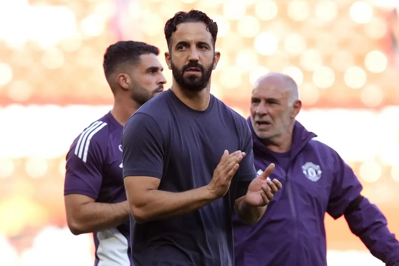 Manchester United manager Ruben Amorim (centre) applauds the fans after the final whistle 