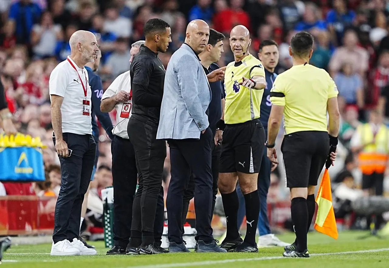 Referee Anthony Taylor spoke with managers Arne Slot and Andoni Iraola after stopping play
