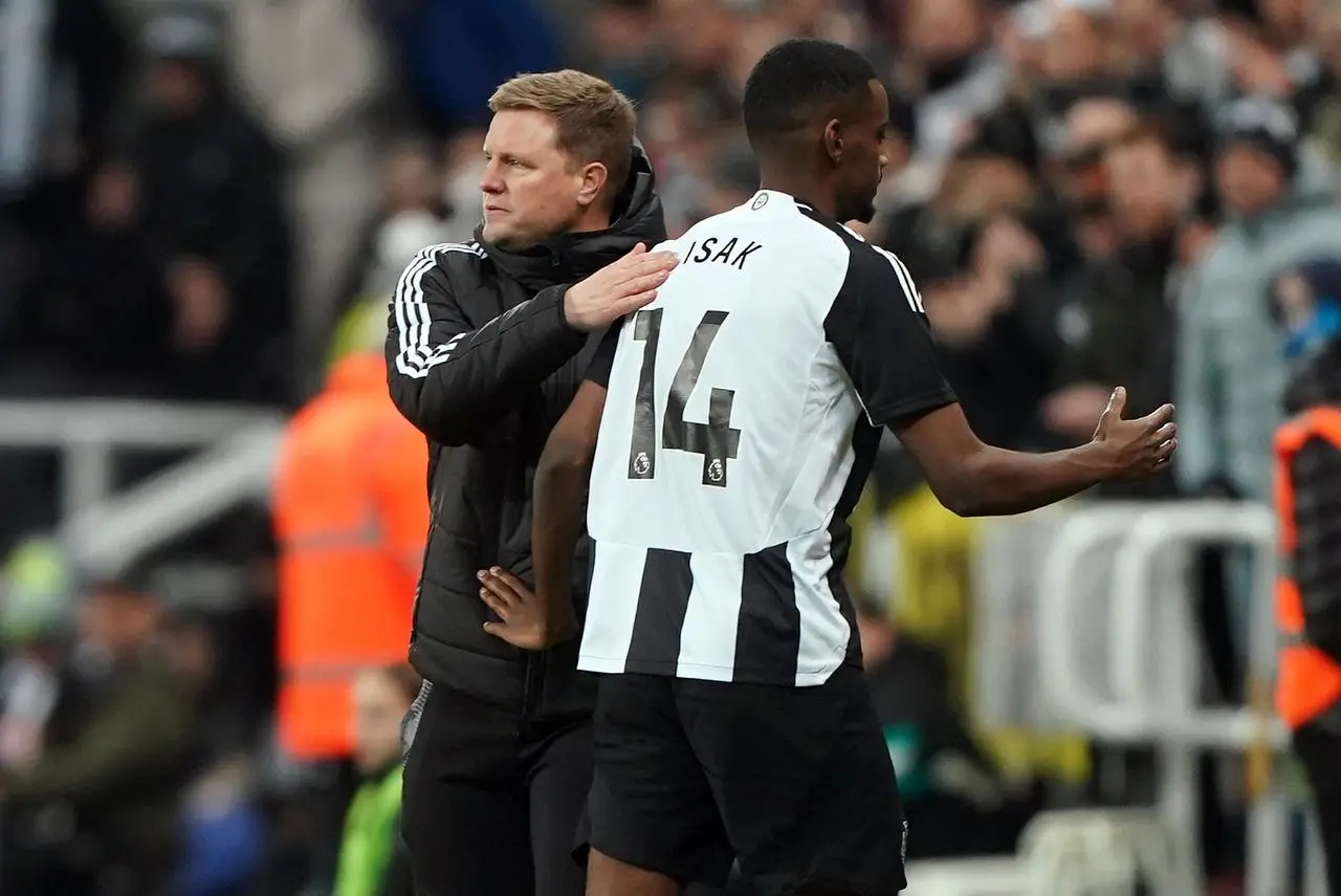 Newcastle boss Eddie Howe, left. pats striker Alexander Isak on the back