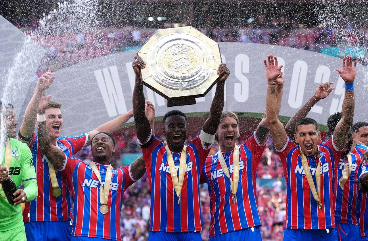 Marc Guehi lifts the Community Shield with team-mates following Palace's win over Liverpool on Sunday