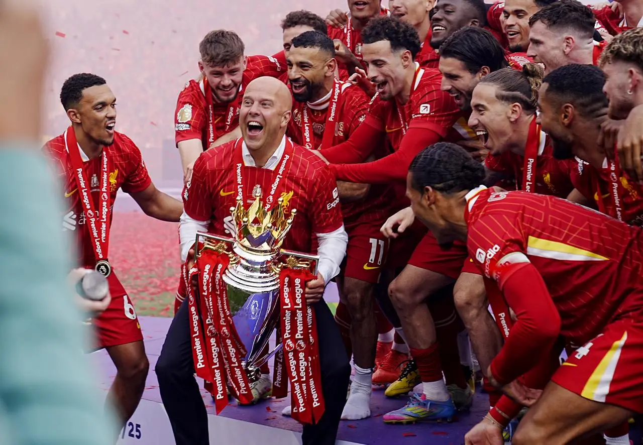 Liverpool manager Arne Slot lifts the Premier League trophy with his players after the Premier League match against Crystal Palace