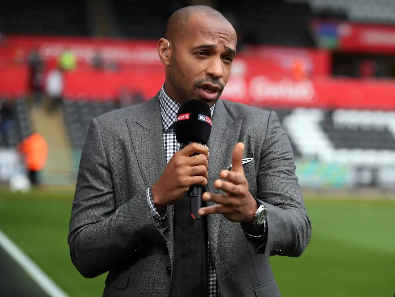 Thierry Henry working as a media pundit at a match