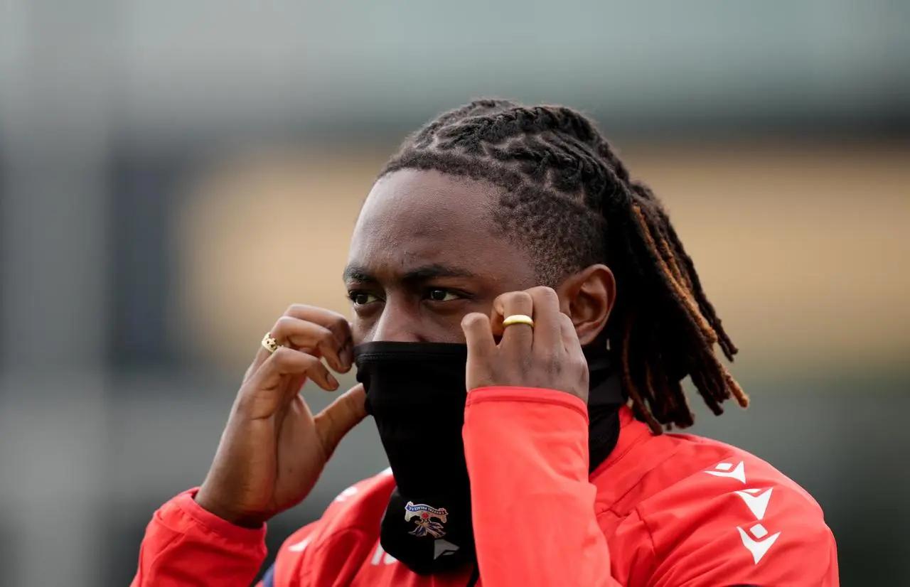 Crystal Palace's Eberechi Eze covers his lower face with a snood 