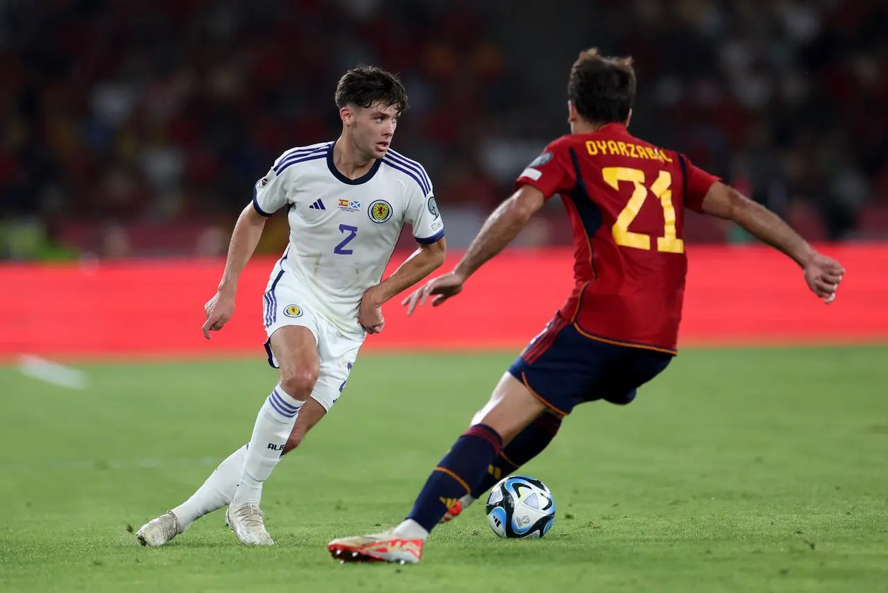 Aaron Hickey (left) against Spain