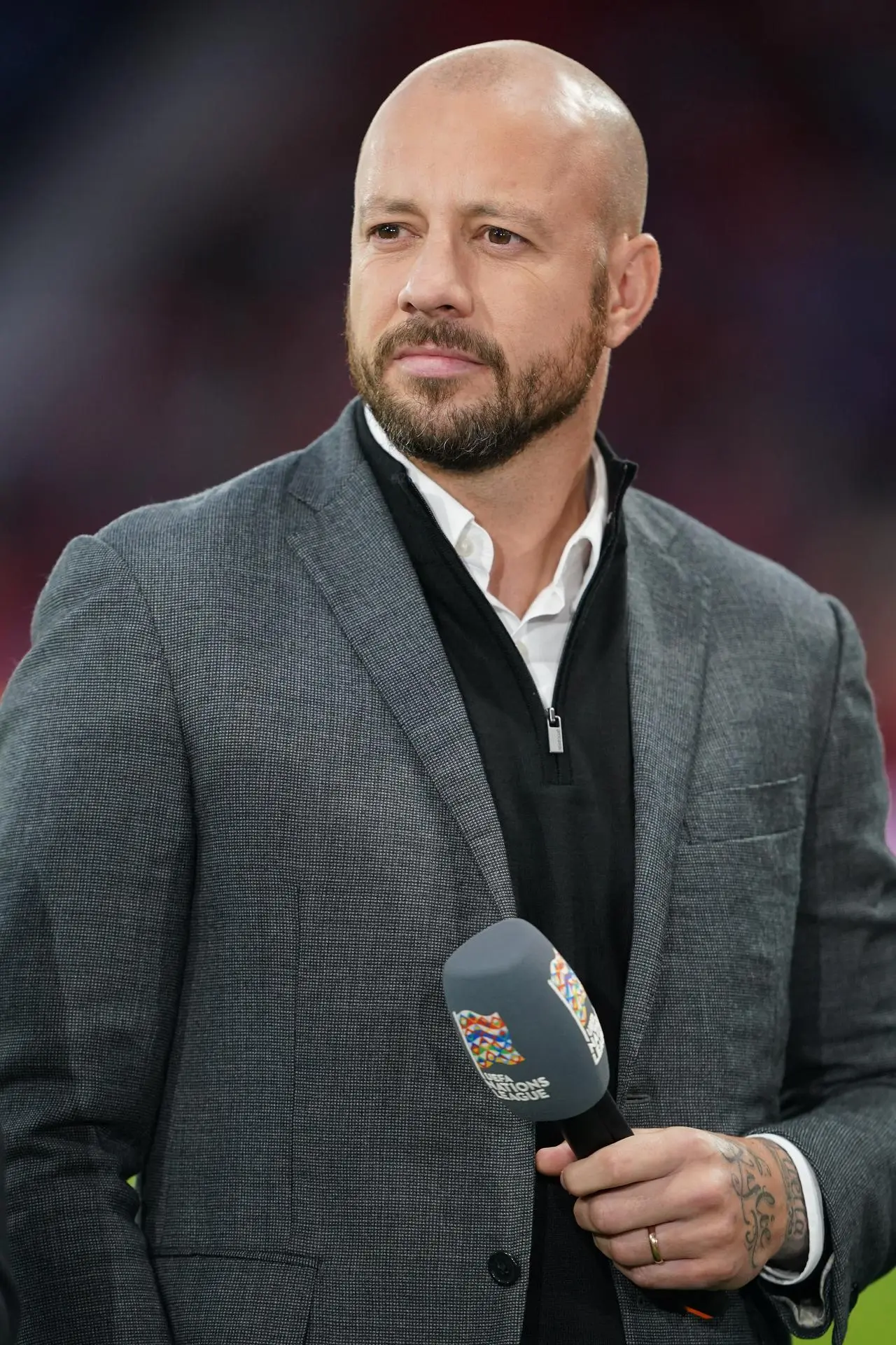 Alan Hutton standing with a microphone in his hand