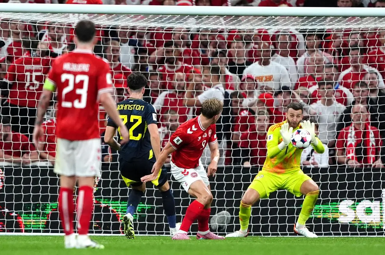 Scotland goalkeeper Angus Gunn saves a shot from Denmark’s Rasmus Hojlund
