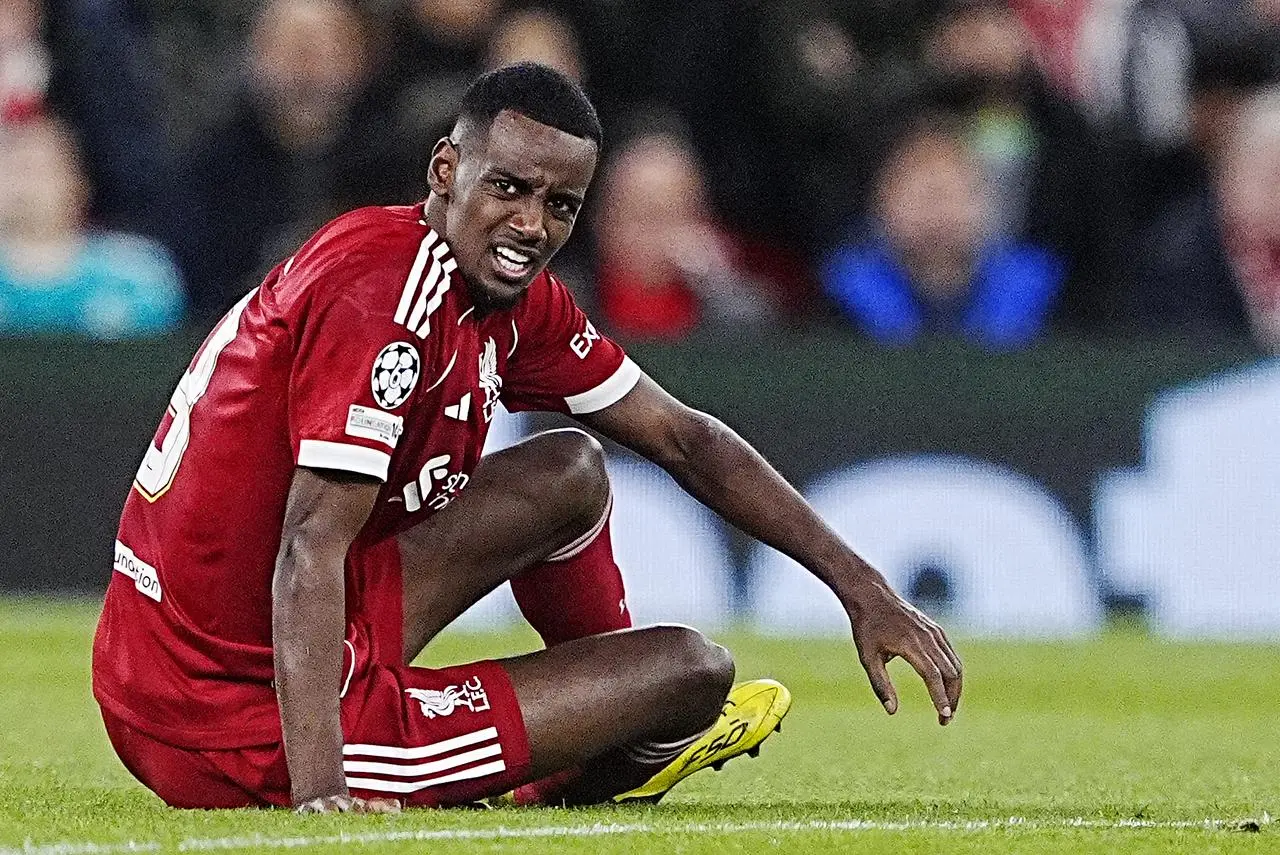 Liverpool’s Alexander Isak grimaces after taking a knock against Atletico Madrid