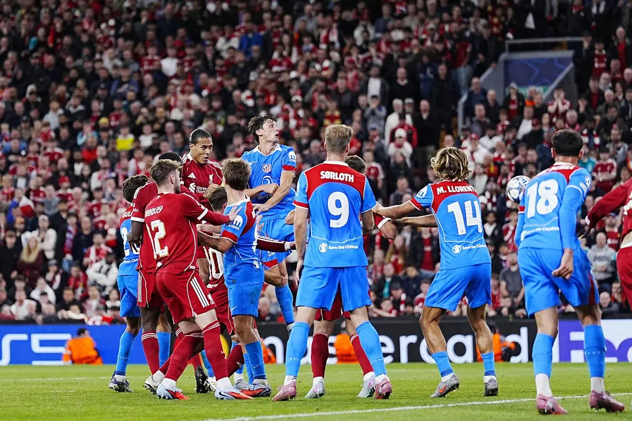 Virgil van Dijk, back left, scores Liverpool’s winner against Atletico Madrid