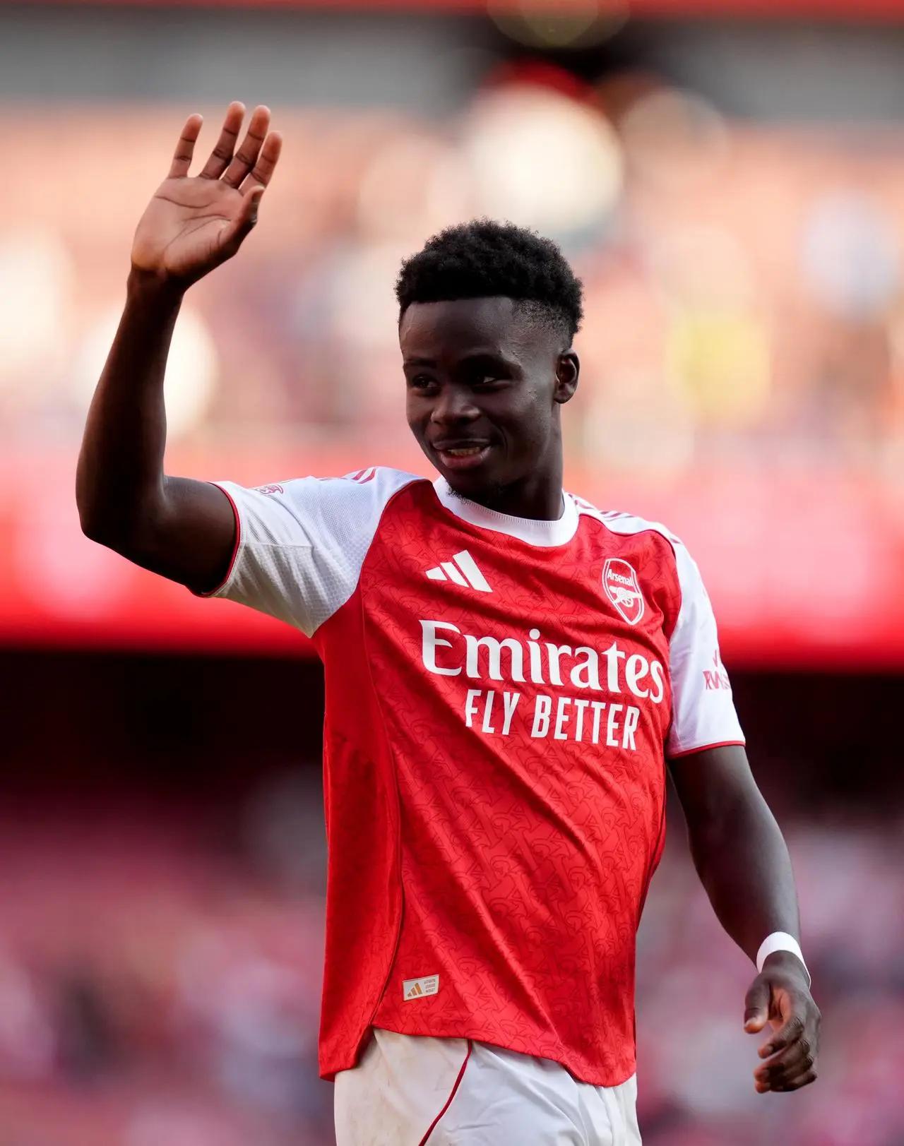 Bukayo Saka waves to the Arsenal fans