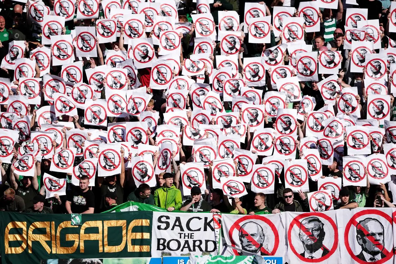 Celtic fans hold banners in protest at board members