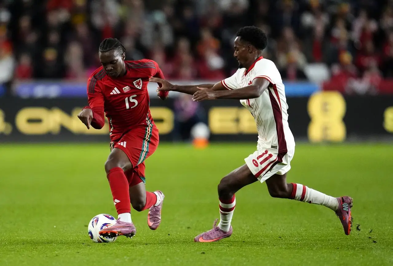 Wales debutant Ronan Kpakio, left, takes on Canada's Ali Ahmed