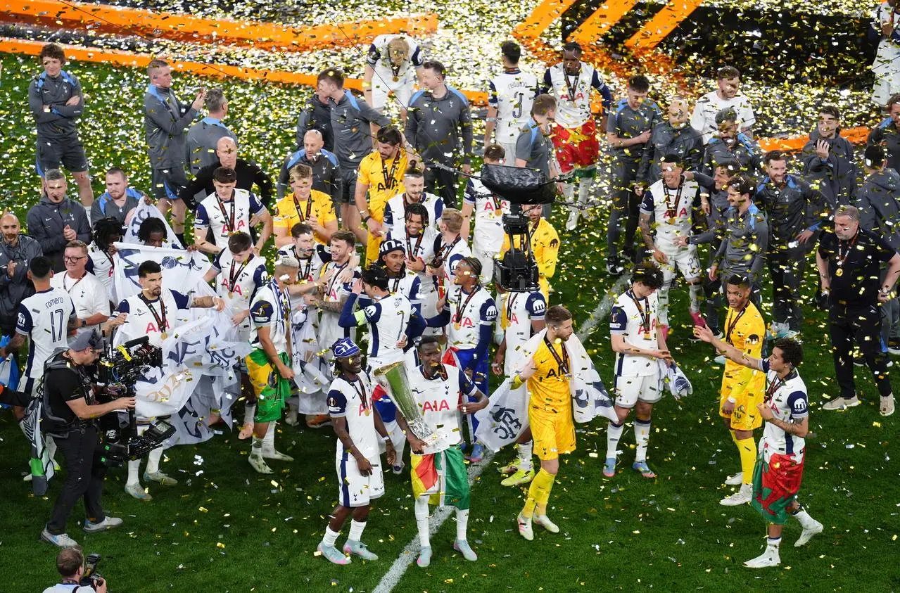 Tottenham players celebrate with the Europa League trophy