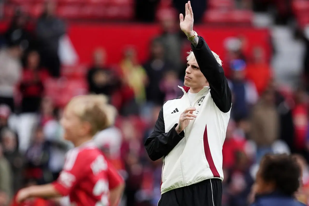 Alejandro Garnacho waves to the Manchester United fans after his final appearance for the club