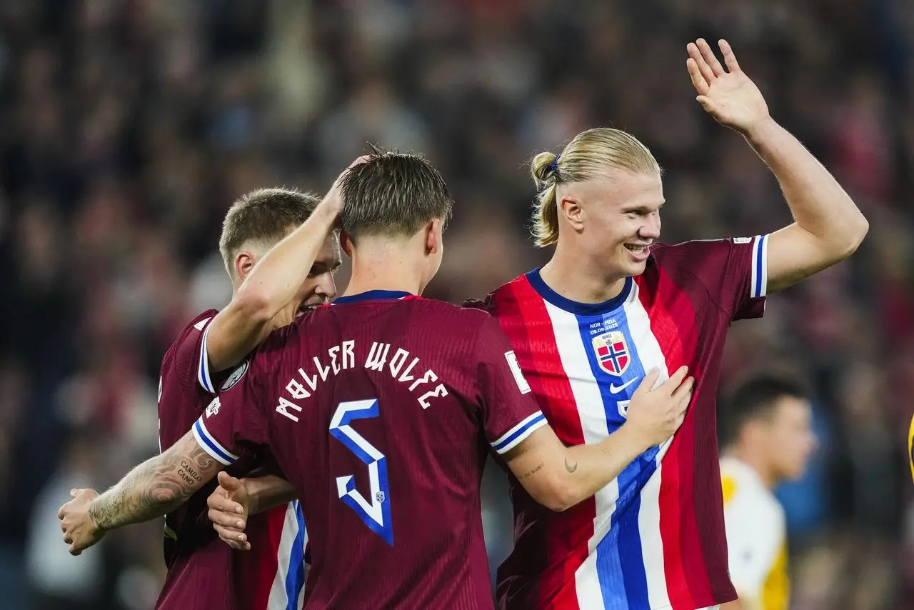 Erling Haaland, right, celebrates one of his five goals in Norway's win over Moldova