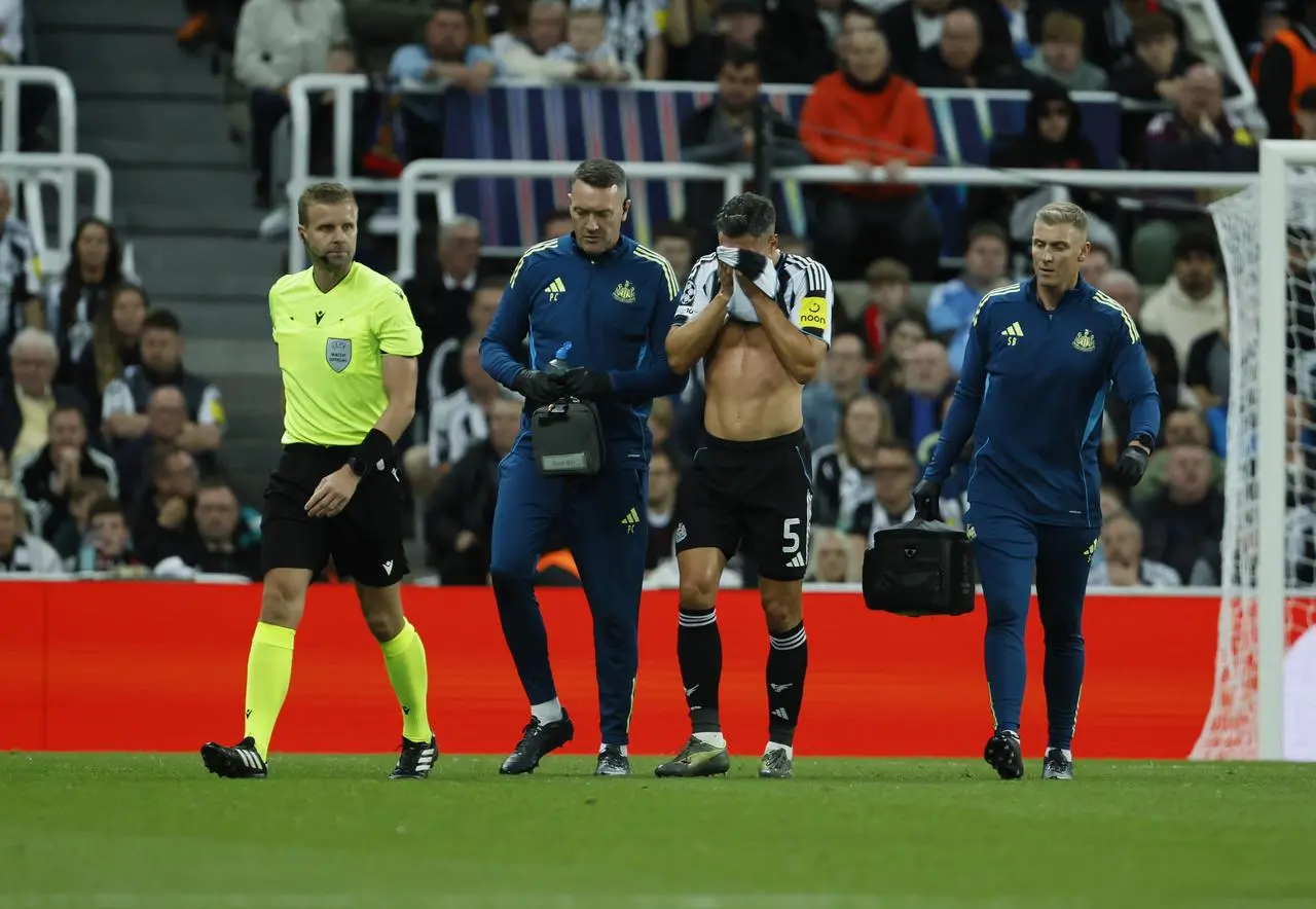 Newcastle’s Fabian Schar goes off injured during the Champions League clash with Barcelona