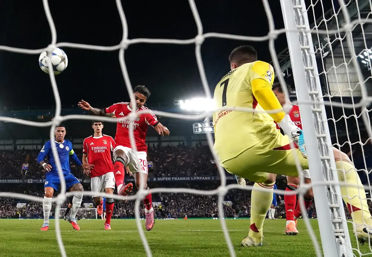 Benfica’s Richard Rios, centre, scores an own goal to give Chelsea victory