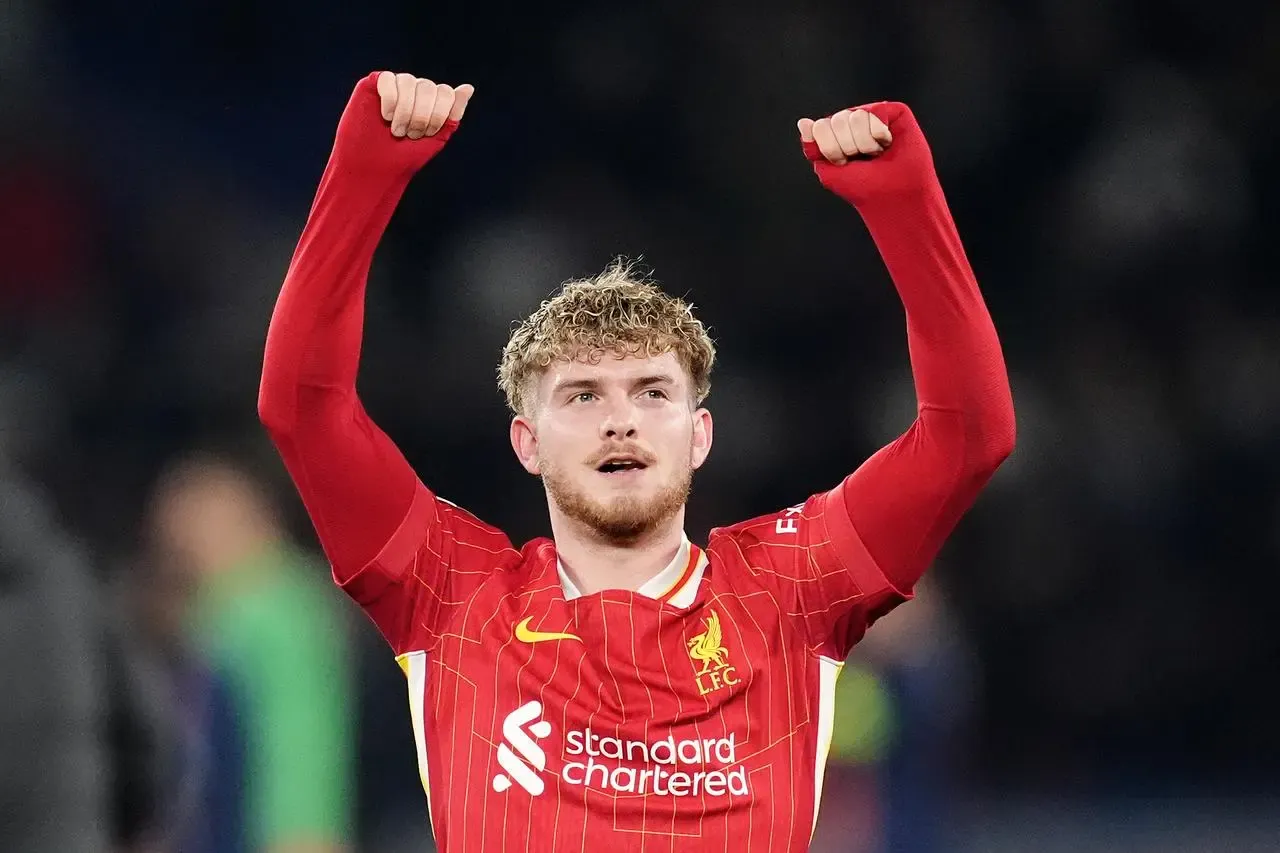 Liverpool’s Harvey Elliott raises his arms to celebrate a win