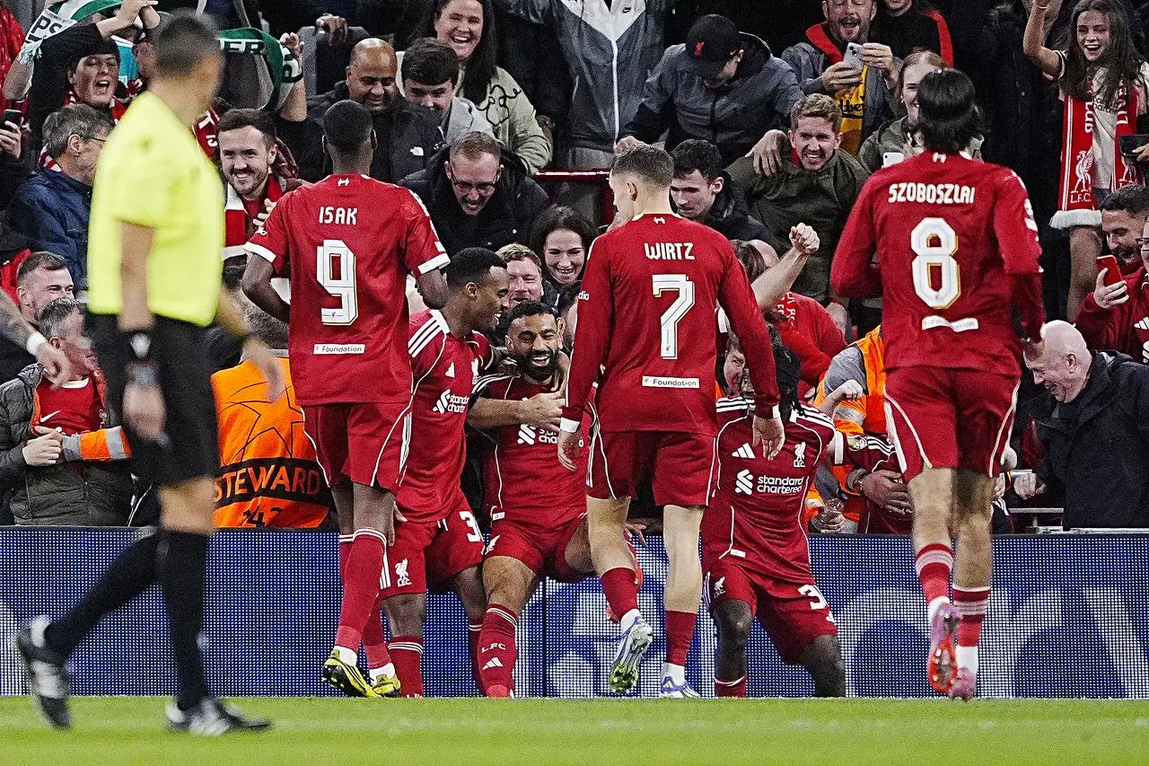 Mohamed Salah, centre left, celebrates after scoring Liverpool's second goal
