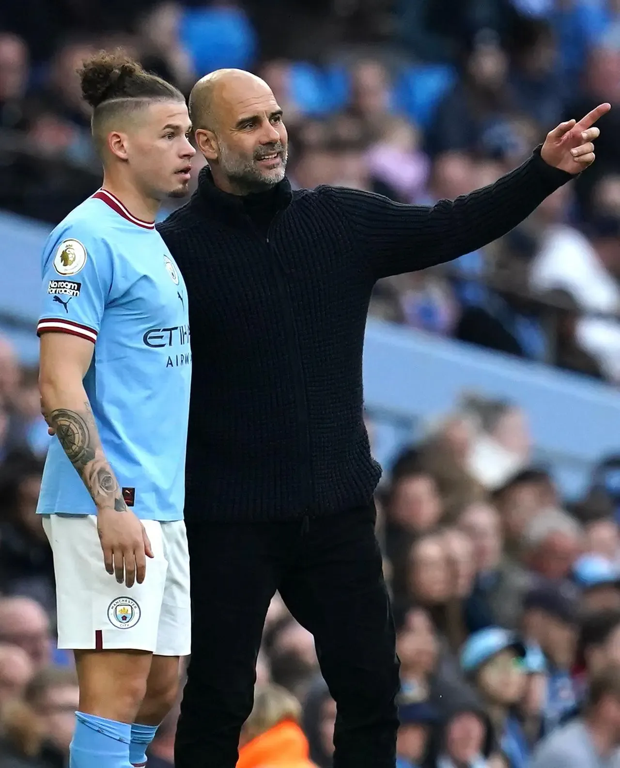Pep Guardiola, right, speaks to Kalvin Phillips 