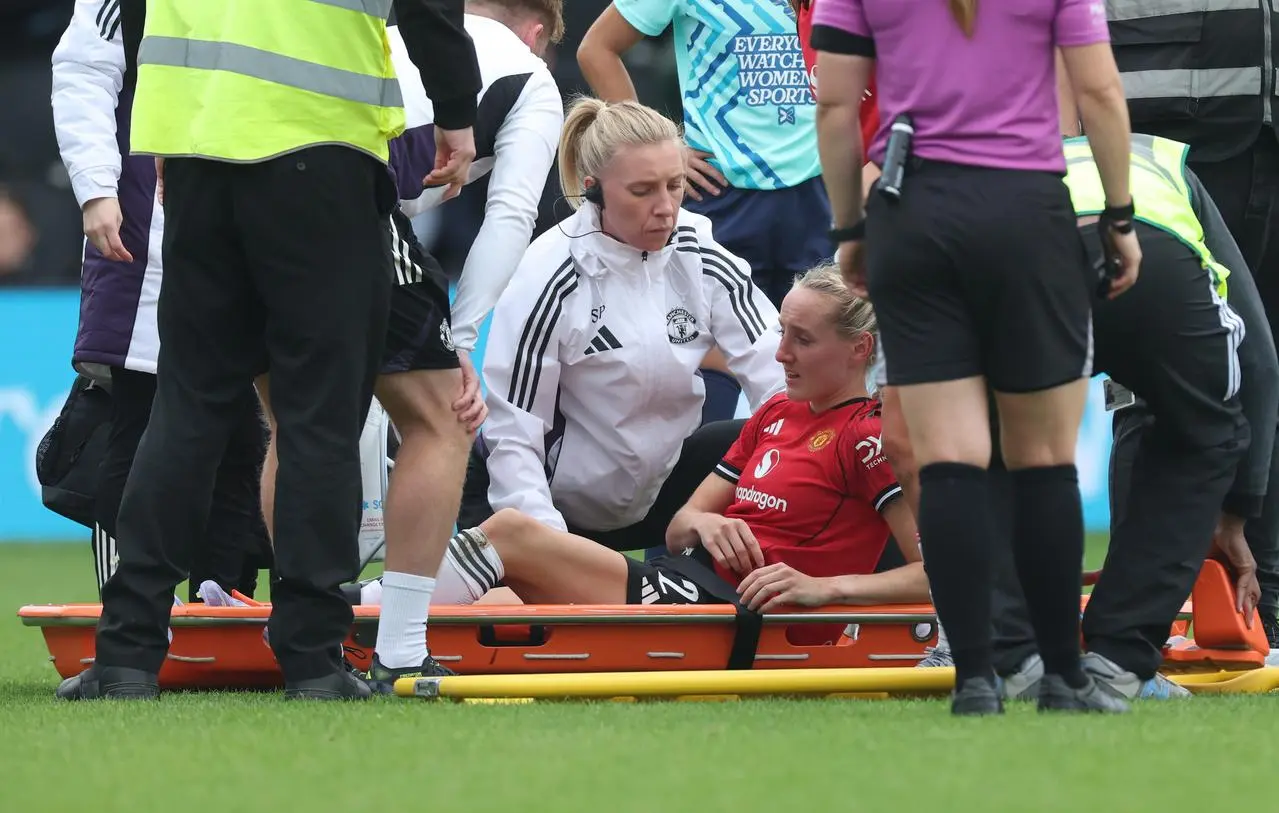 Millie Turner lies on a stretcher