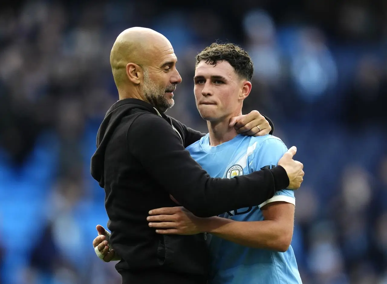 Pep Guardiola embraces Phil Foden
