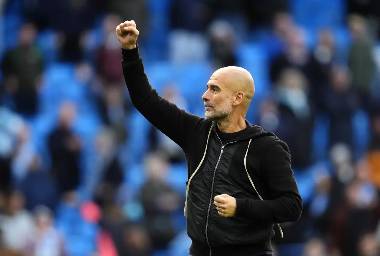 Manchester City manager Pep Guardiola salutes the fans