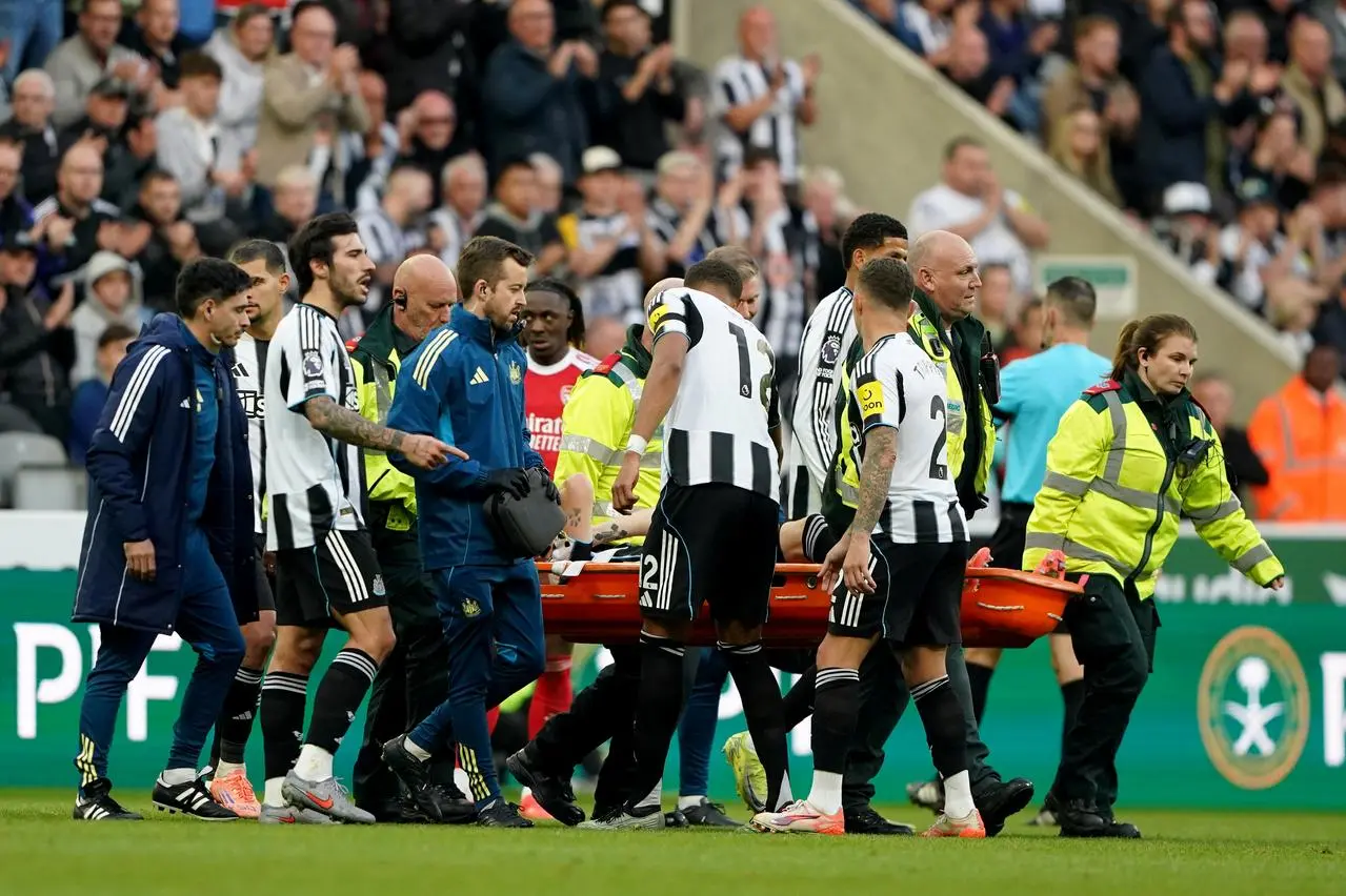 Newcastle defender Tino Livramento is carried off after suffering a knee injury against Arsenal