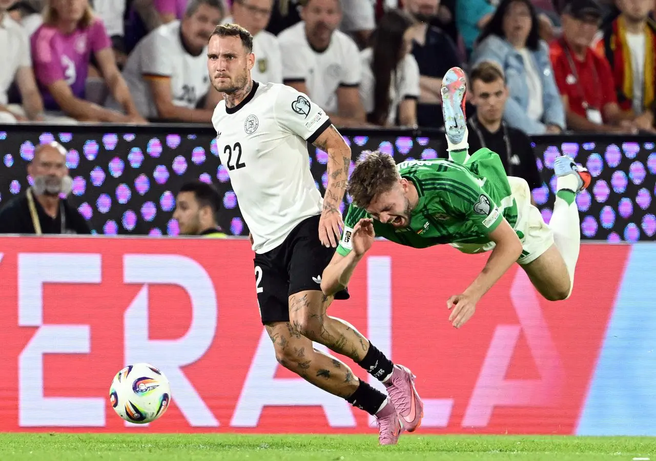 Germany’s David Raum and Northern Ireland’s Conor Bradley battle for the ball