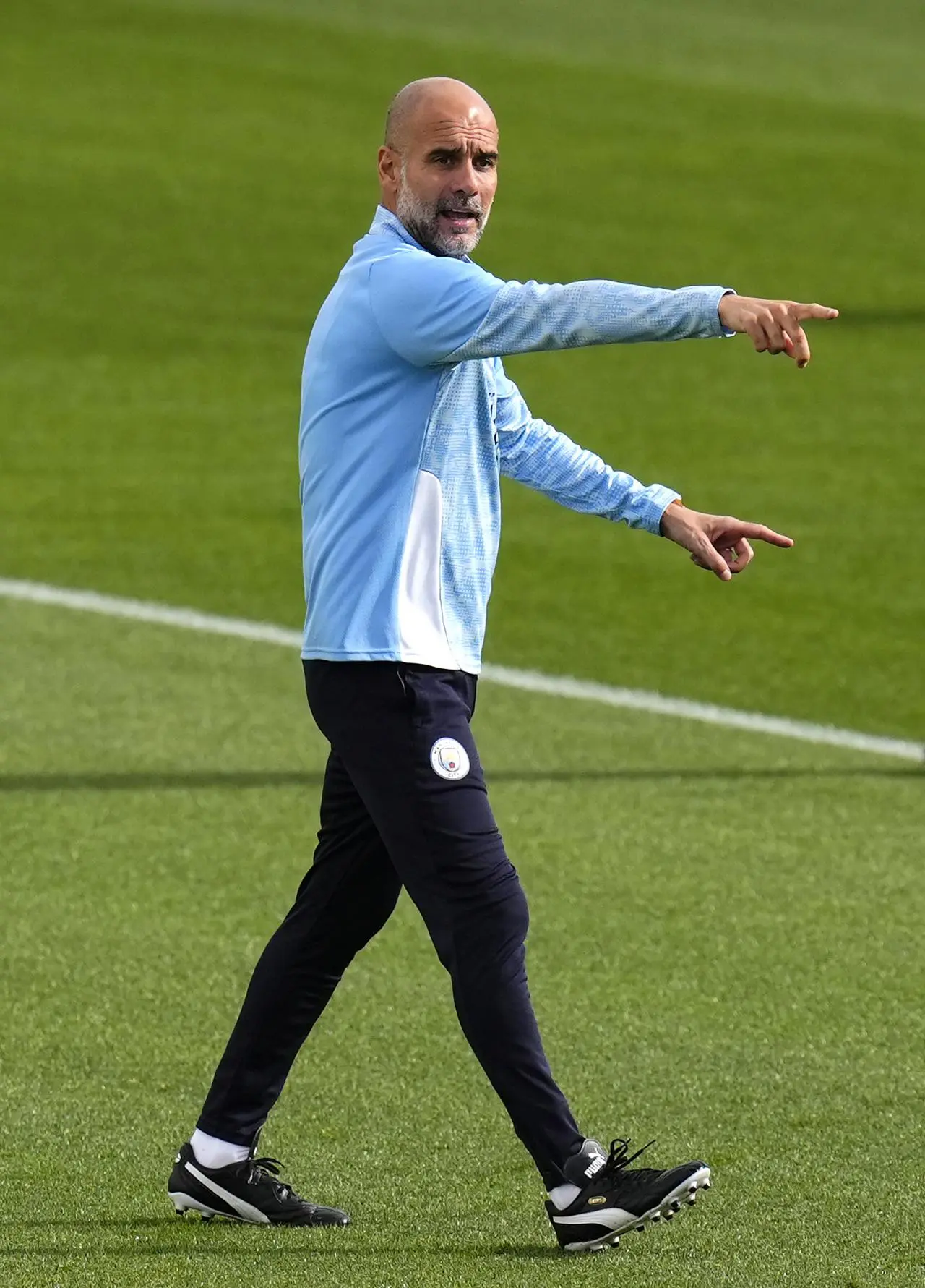 Pep Guardiola gestures to players during a training session