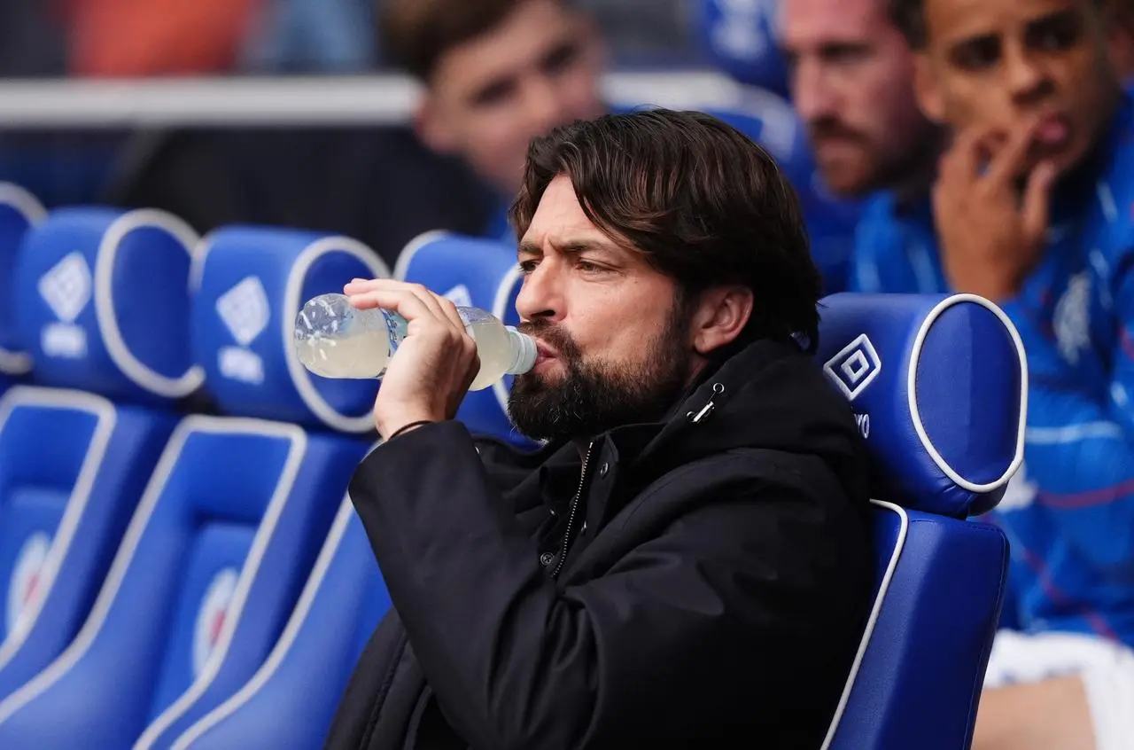 Rangers manager Russell Martin takes a drink