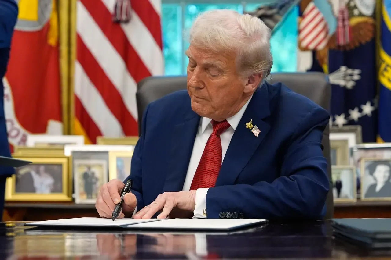 United States President Donald Trump signs a document