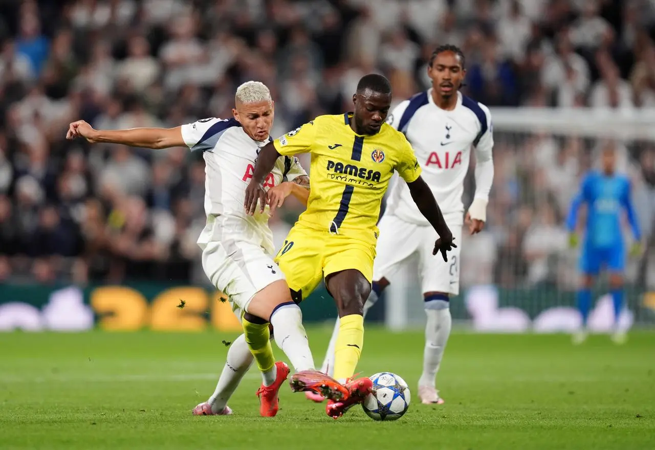 Tottenham’s Richarlison tackles Villarreal’s Nicolas Pepe, right