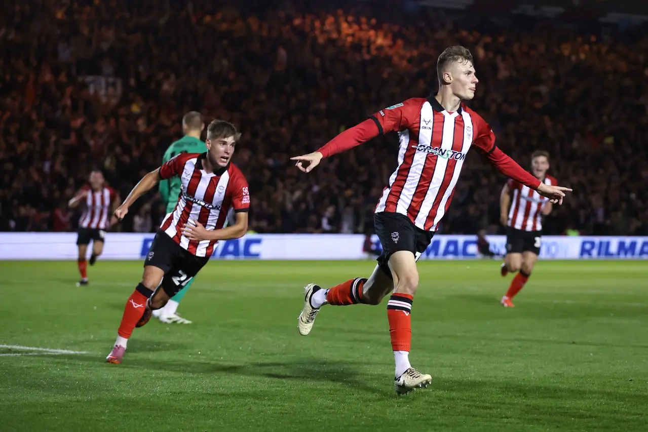 Rob Street, right, celebrates after giving Lincoln the lead against Chelsea