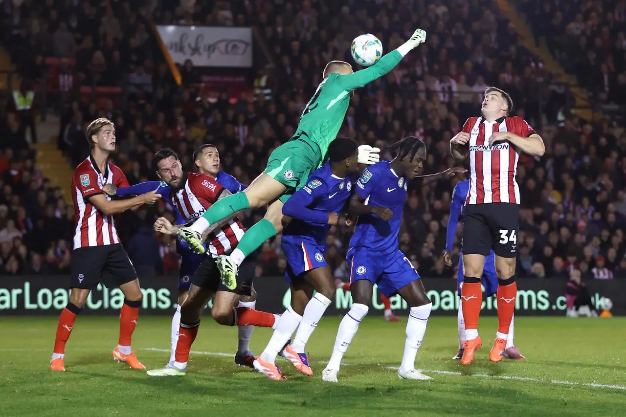 Chelsea goalkeeper Filip Jorgensen tries and fails to punch the ball away from danger against Lincoln