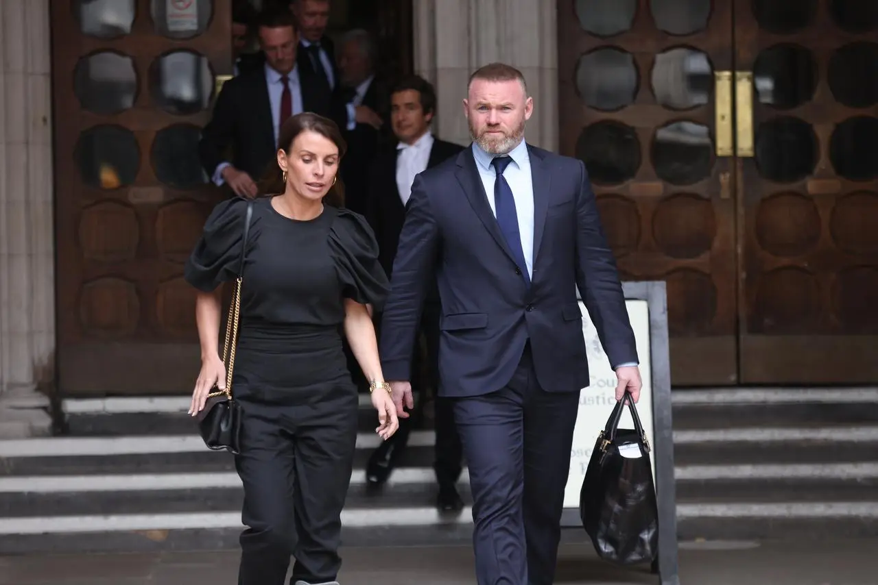 Wayne and Coleen Rooney hold hands