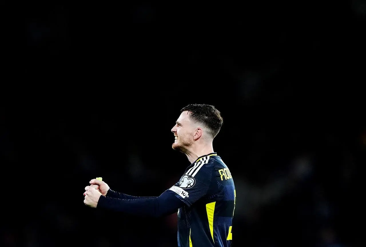 Andy Robertson clenches his fists in celebration