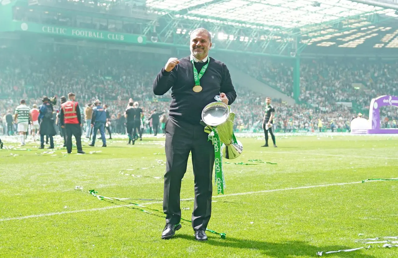 Ange Postecoglou holding a trophy