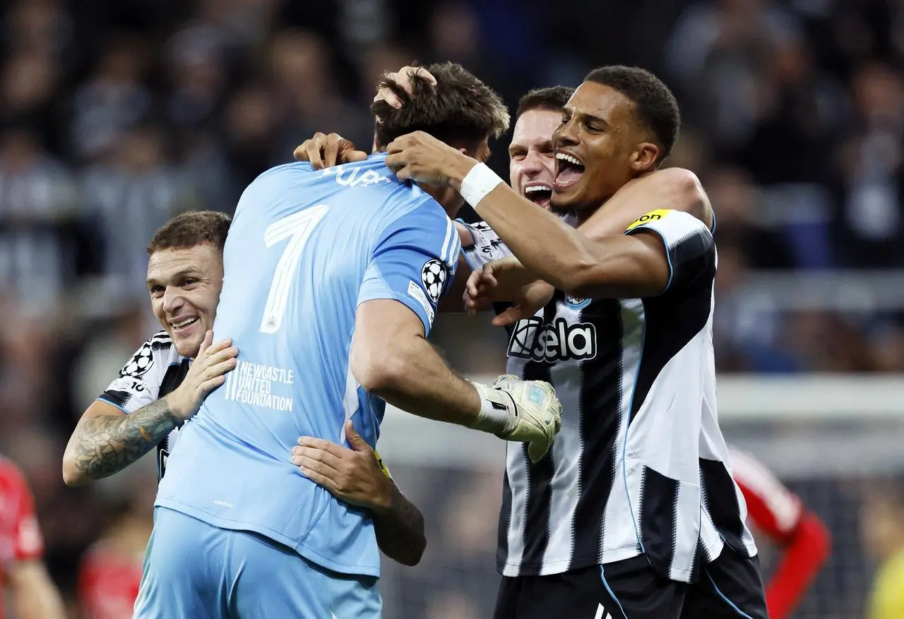 Newcastle goalkeeper Nick Pope (centre) celebrates with team-mates