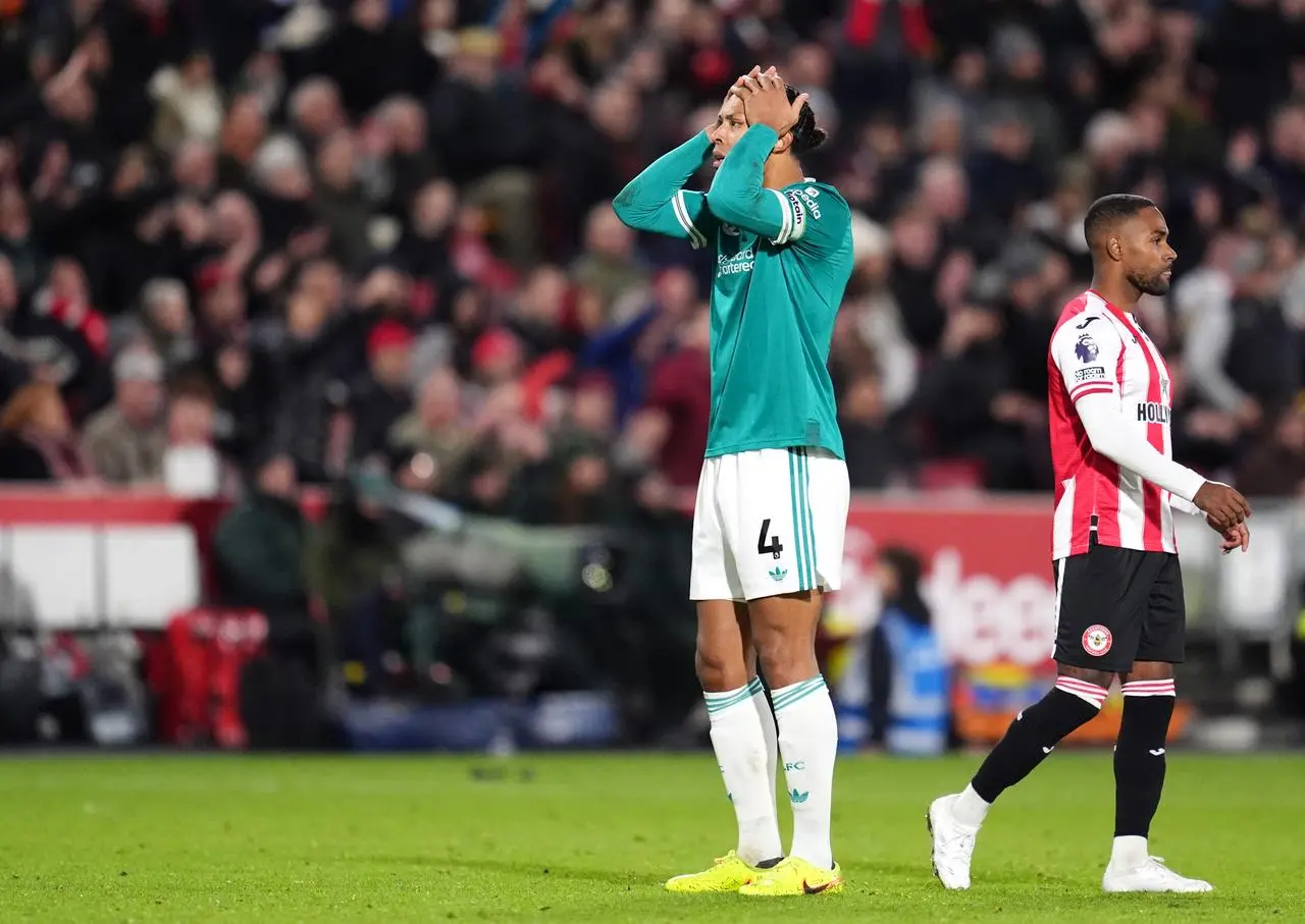 Virgil van Dijk covers his face with his hands