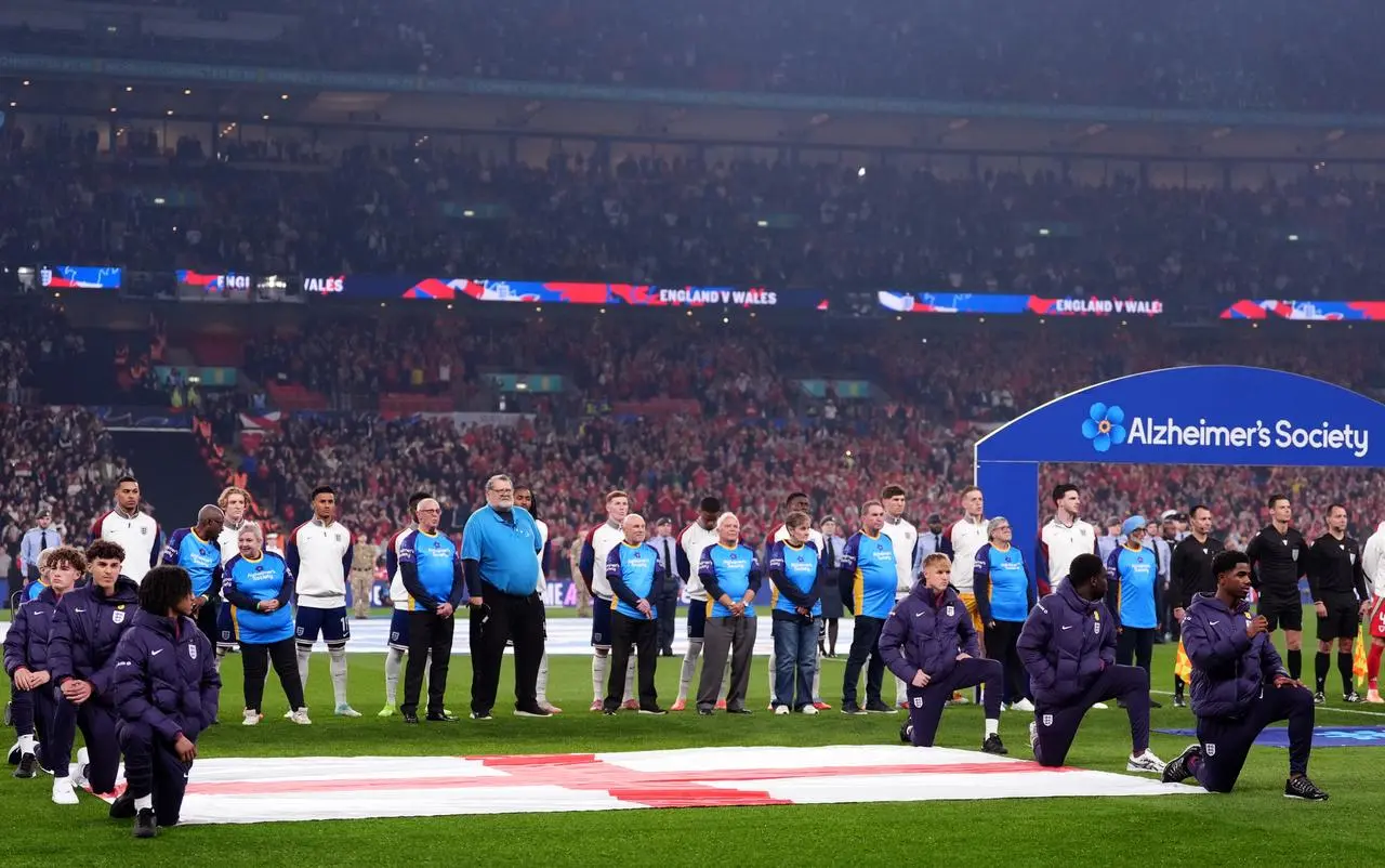 Fans line up with players before the match