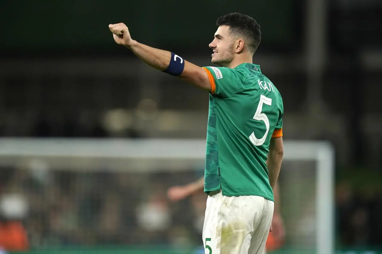 Republic of Ireland defender John Egan salutes fans with a clenched fist