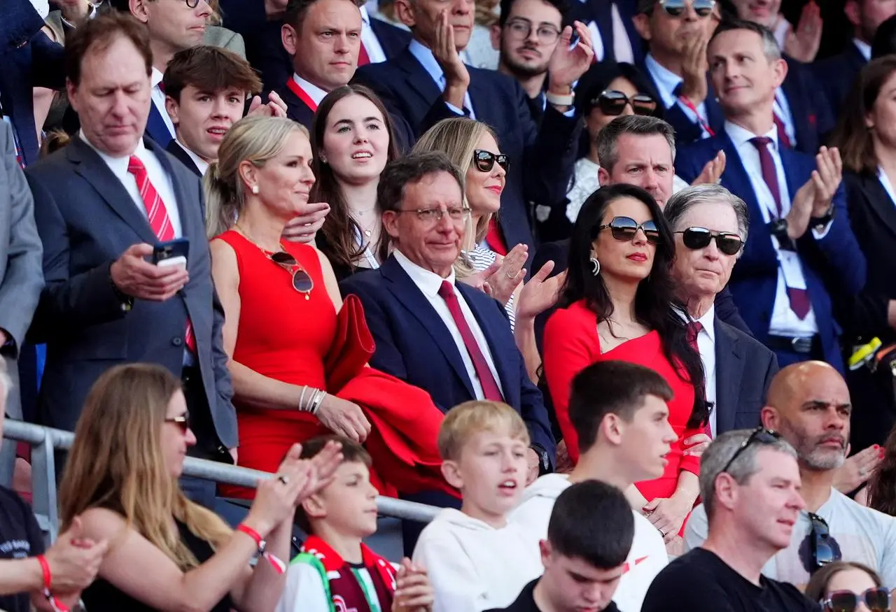 Liverpool chairman Tom Werner, centre, and owner John W Henry, right, in the directors box at Anfield