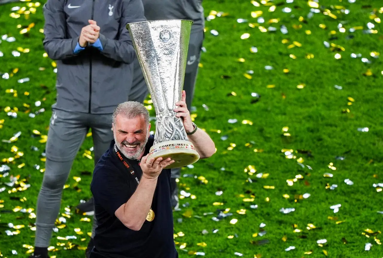 Tottenham manager Ange Postecoglou lifts the Europa League 