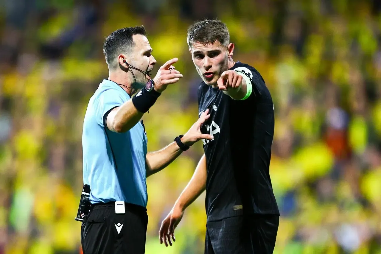 Referee Ivan Kruzliak speaks with Tottenham Hotspur’s Micky van de Ven during the Champions League game at Bodø/Glimt 