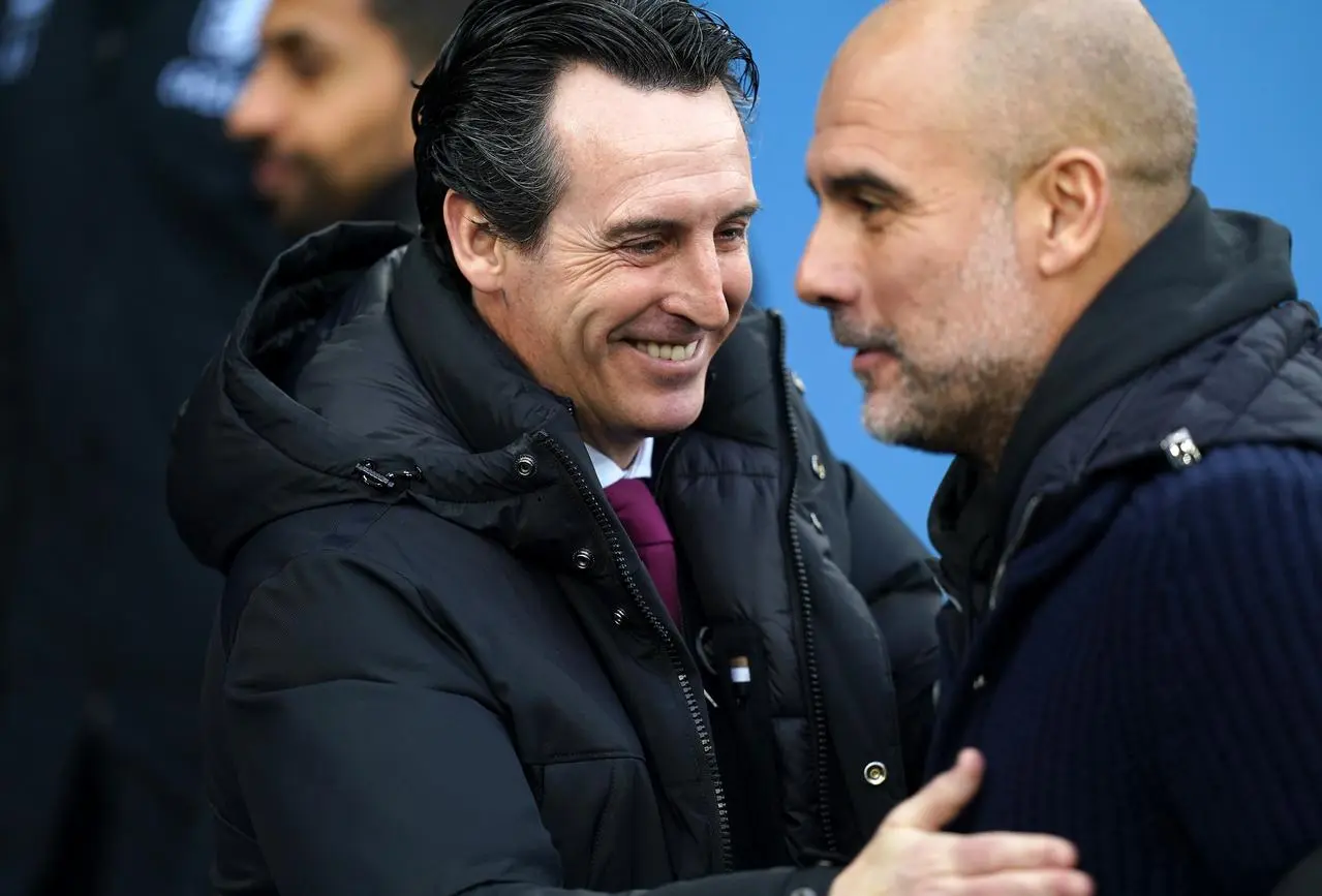 Unai Emery and Pep Guardiola embrace on the touchline