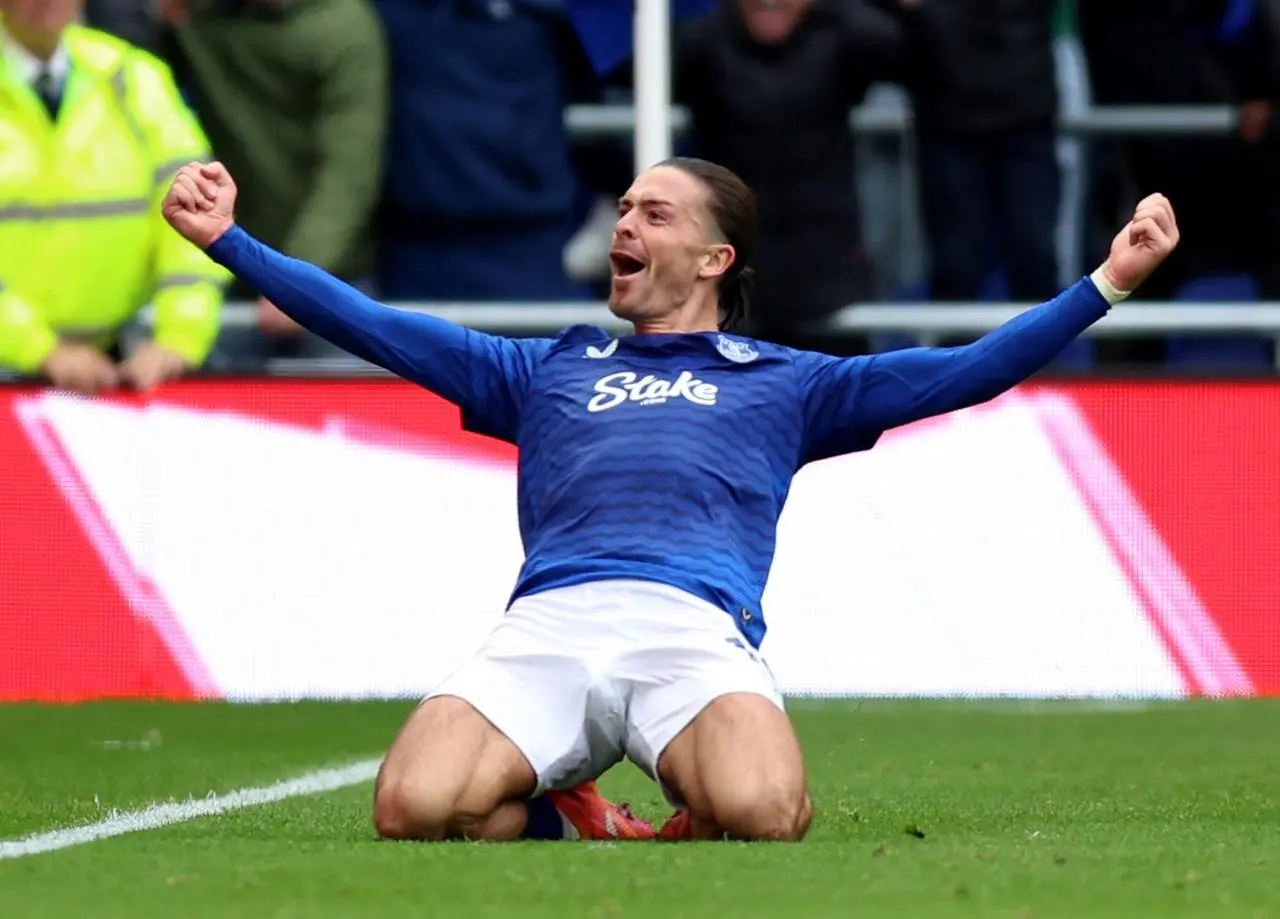 Jack Grealish slides on his knees to celebrate scoring a goal for Everton