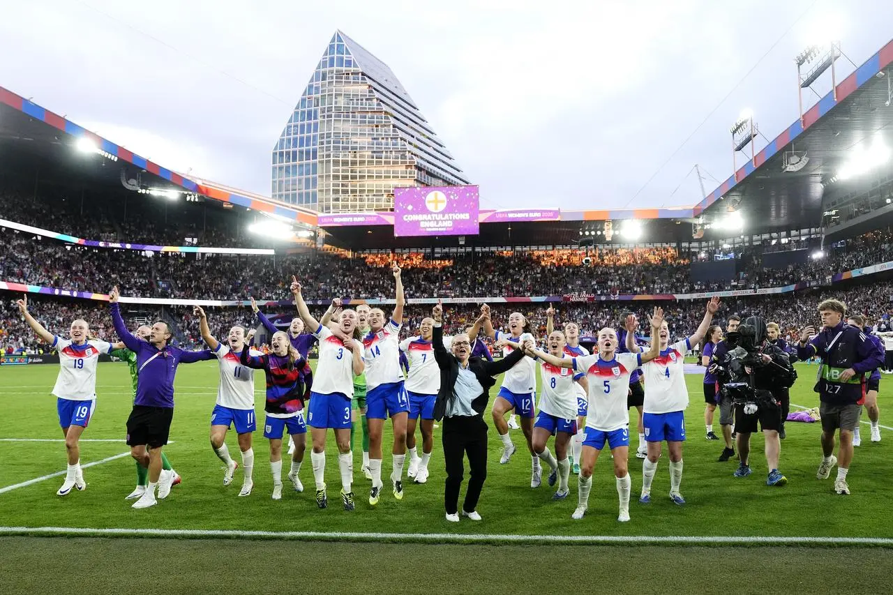 Wiegman (centre) and players celebrate after Chloe Kelly's winning penalty during the Euro 2025 final shootout in Basel