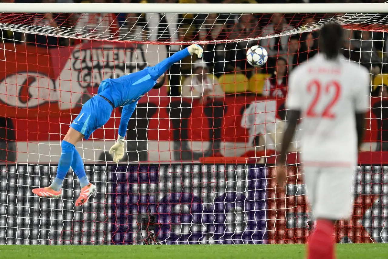 Tottenham’s goalkeeper Guglielmo Vicario makes a save