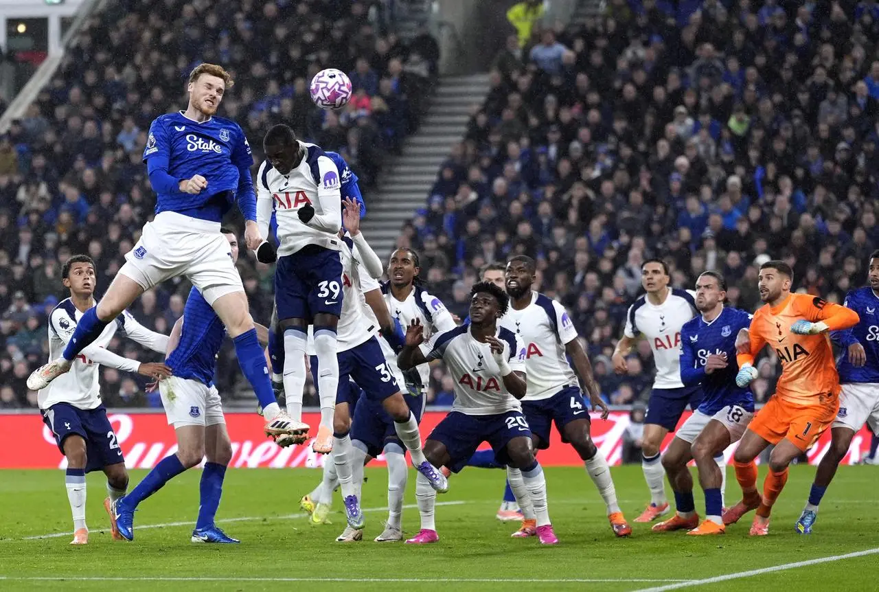 Everton’s Jake O’Brien, top left, heads home as Tottenham goalkeeper Guglielmo Vicario, second right, is sandwiched by Jack Grealish and Iliman Ndiaye