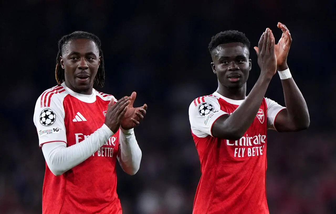 Eberechi Eze (left) and Bukayo Saka, right, on the bench applaud the fans 